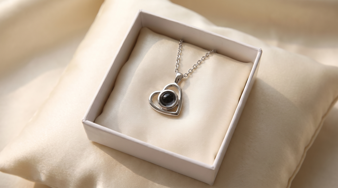 Heart pendant necklace resting inside a gift box on a satin pillow