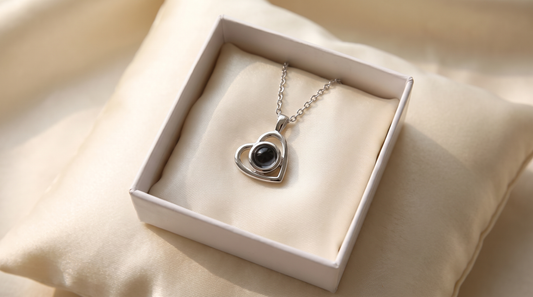 Heart pendant necklace resting inside a gift box on a satin pillow