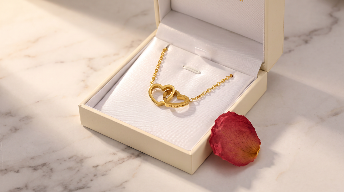 Engraved Double Heart Necklace in gold resting on a white satin gift box