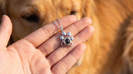 Dog mom wearing a silver pet photo necklace with her dog