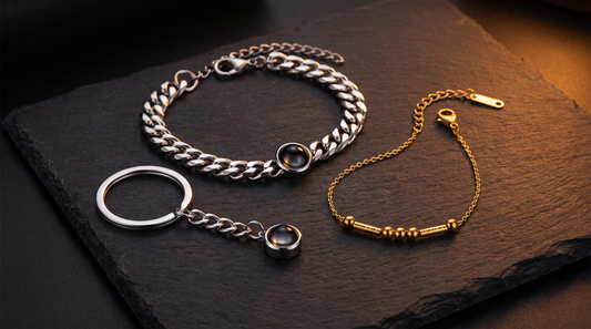 Cuban link bracelet, circle keychain, and Morse code bracelet on a dark surface