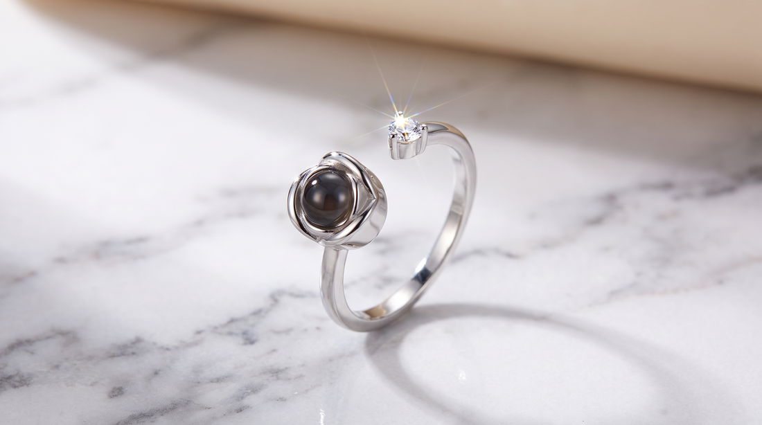 Sterling silver ring with picture inside resting on white marble