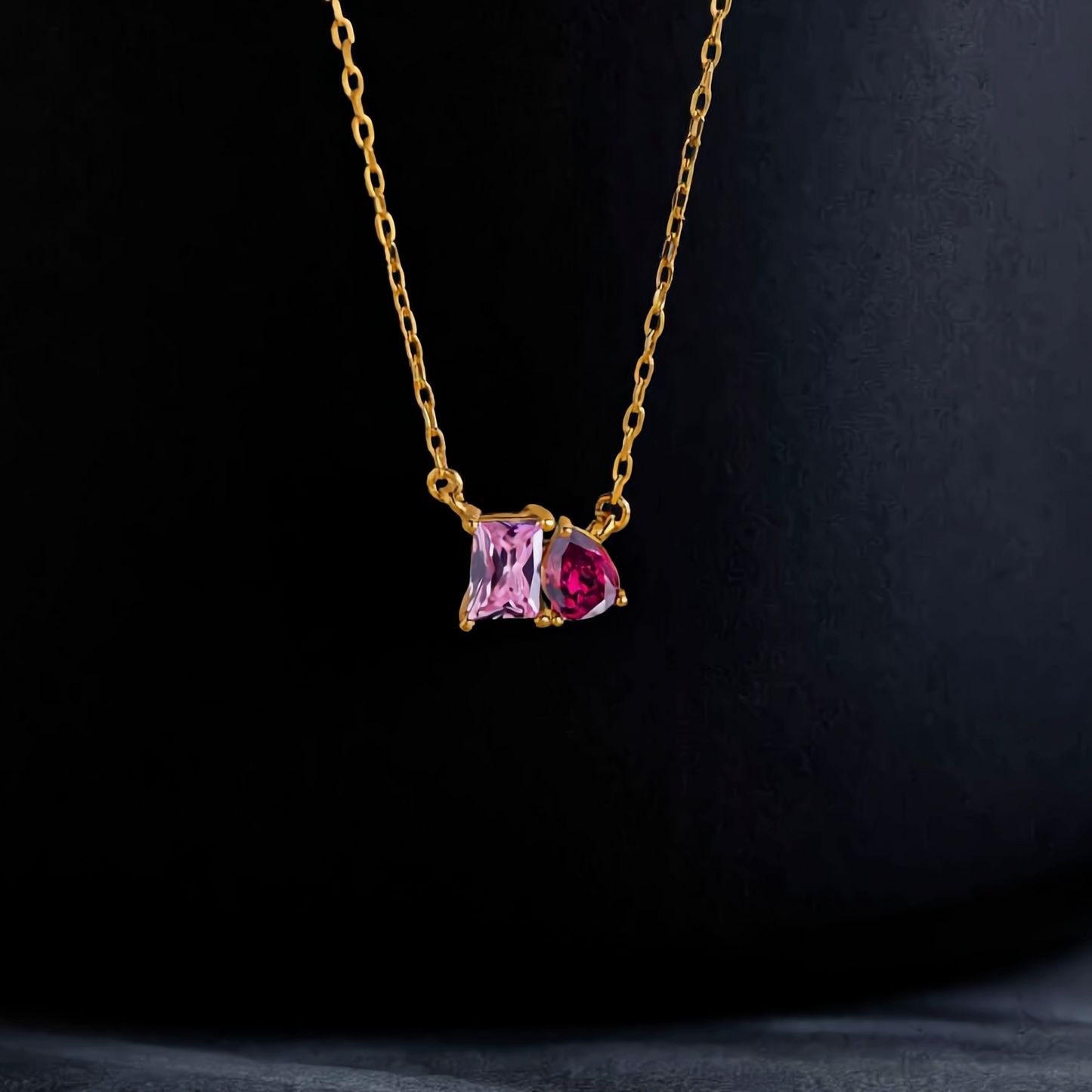 Duo birthstone necklace on black background