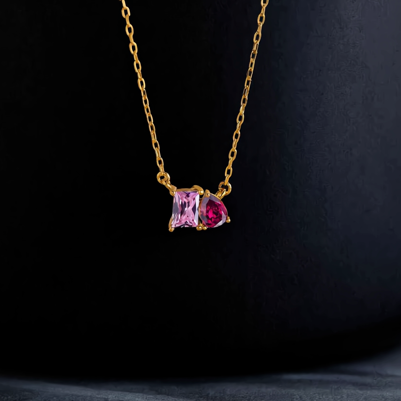 Duo birthstone necklace on black background