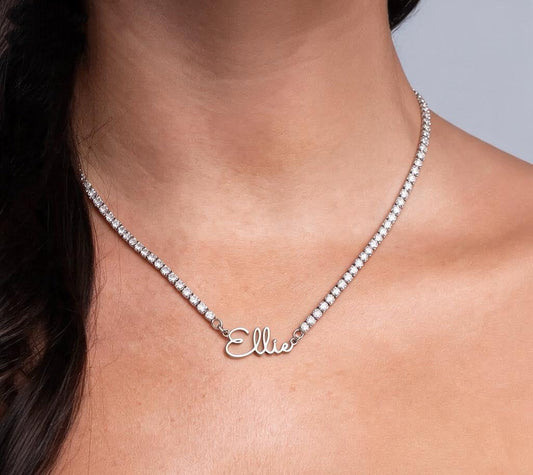 Custom signature name tennis necklace worn on neck in silver, personalized as Ellie