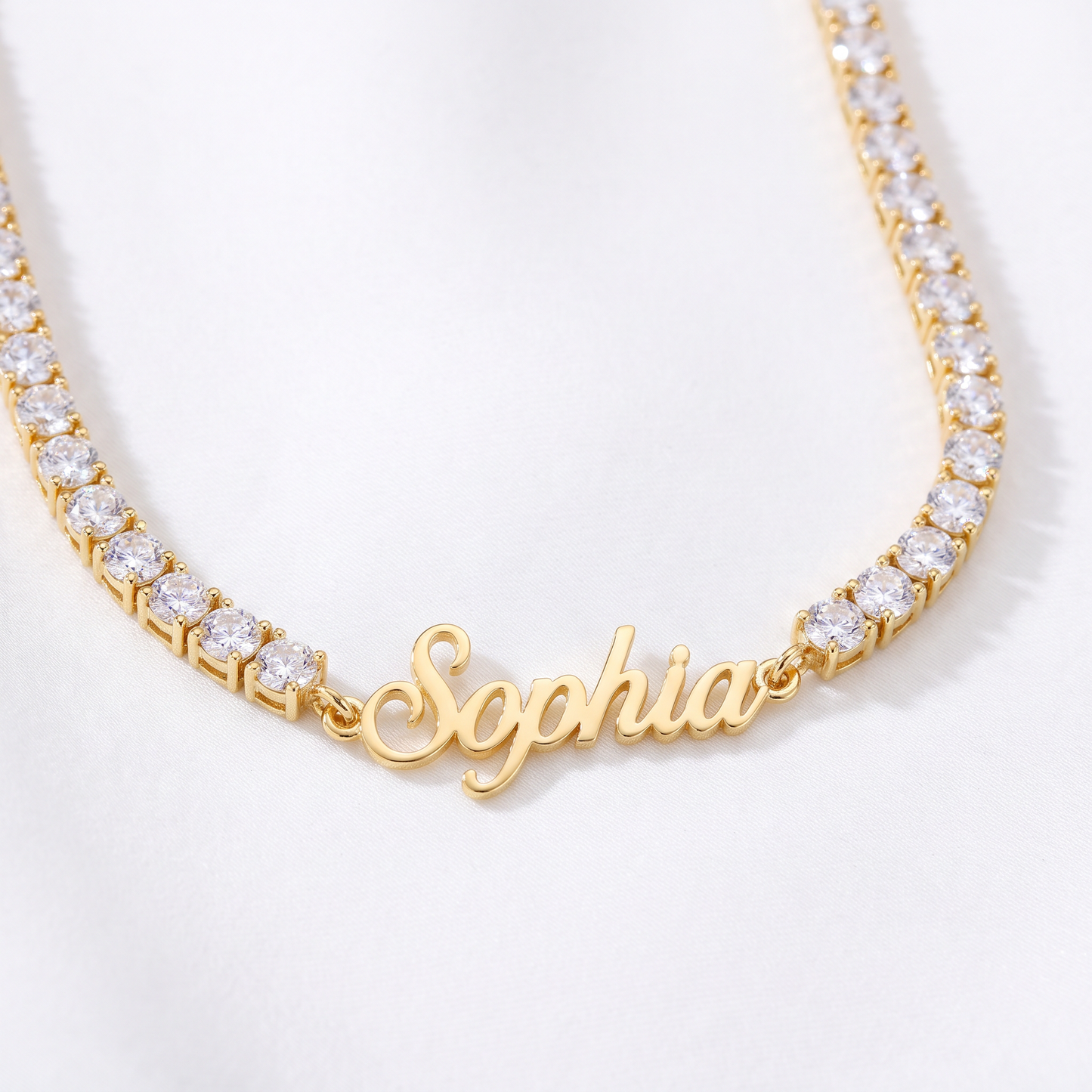 Custom signature name tennis necklace, close up in gold with name plate