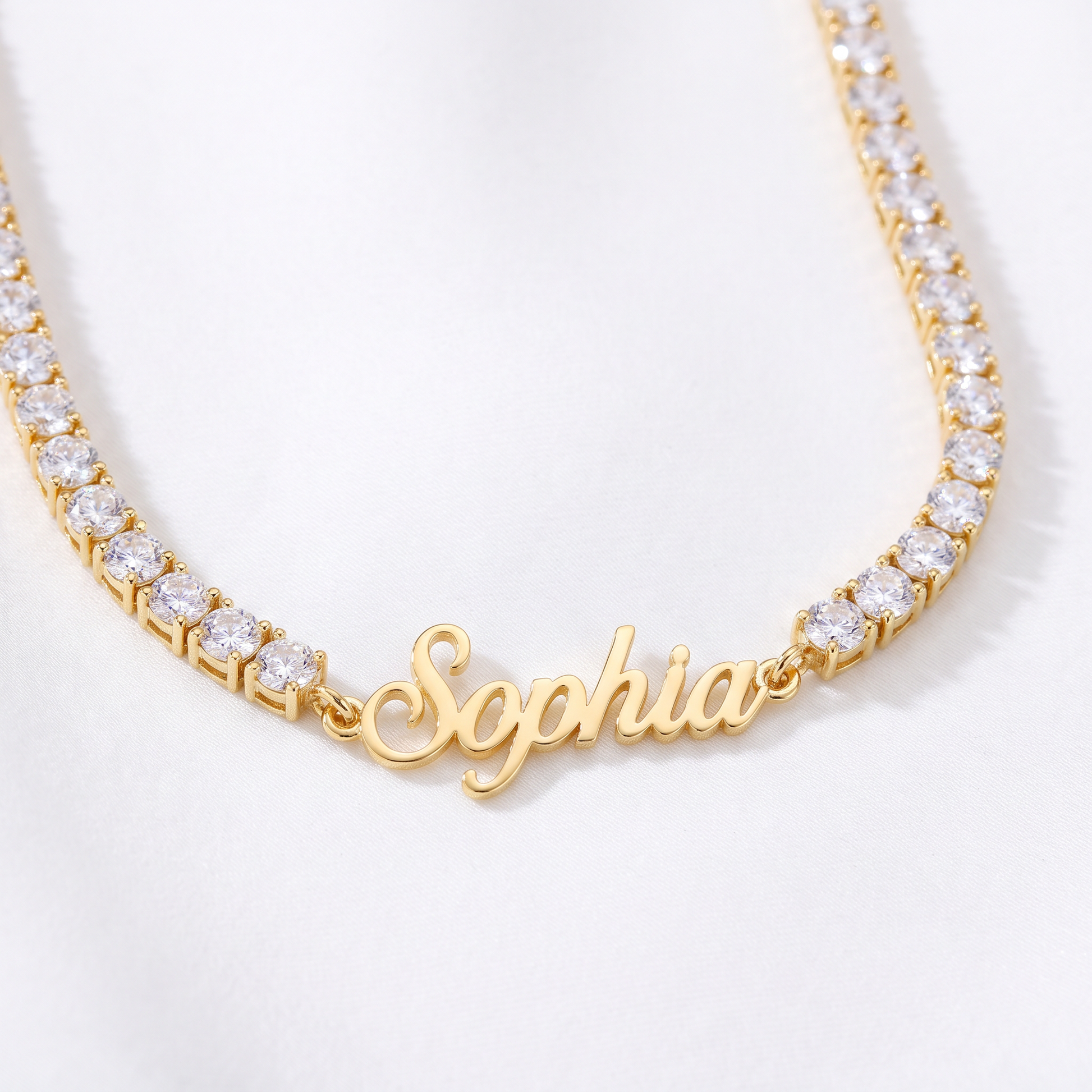Custom signature name tennis necklace, close up in gold with name plate