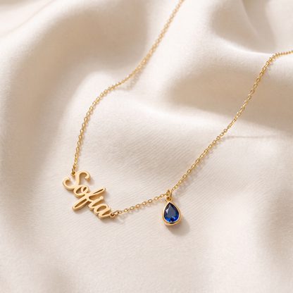 Gold personalized name necklace with sapphire blue birthstone charm